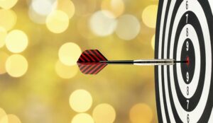 close up dart arrow hitting on target center on bullseye in dart