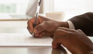 A person signs a document