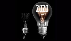 Two lightbulbs in contrast with a black background. One has 2020 lit up, and the other has 2019 in the background