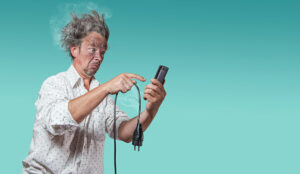 A picture of a man experience a bad electric shock on the phone