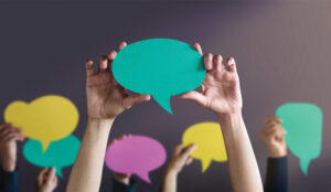 A picture of people holding up speech bubbles