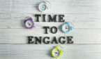 A picture of Clocks and phrase Time to Engage on wooden background