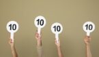 Panel of judges holding signs with highest score