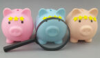 Magnifying glass and piggy banks with yellow stars on gray background.