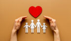 Hands holding family figure. Life and health insurance concept.