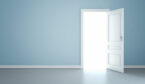 A blue wall with an open door leading to light