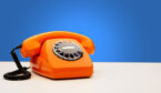 Vintage Orange Telephone On Blue Background