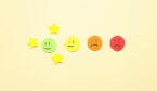 Customer experience concept with rating faces and stars