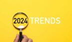 yellow background with the words 2024 trends and a magnifying glass