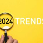 yellow background with the words 2024 trends and a magnifying glass
