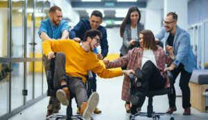 Business people having fun while racing on office chairs