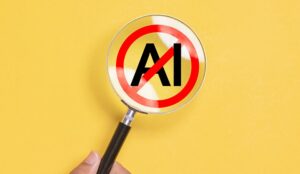 Hand holding magnifying glass focus to No AI symbol on yellow background