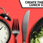 Plate of food, cutlery, alarm clock - lunch schedule concept
