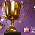 Golden trophy with falling star-shaped spangles on purple background