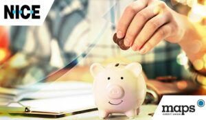 Woman putting money into piggy bank at table