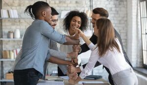 Group of company employees having fun in team building meeting