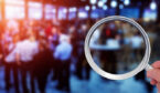 Blurred background of an event with a magnifying glass in the front