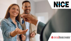 couple receiving keys of their new home from real estate agent