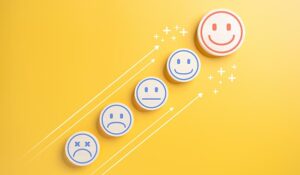 Sad to happy faces on yellow background