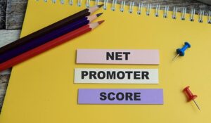 Concept of Net Promoter Score write on sticky notes isolated on Wooden Table