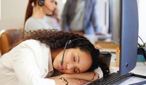 Call centre agent sleeping at their desk